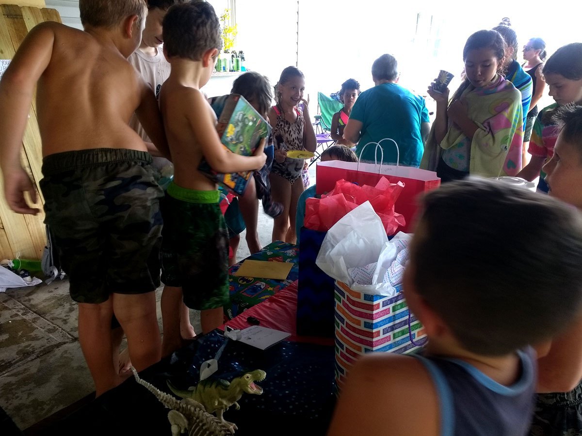 Opening gifts during a birthday party on the farm